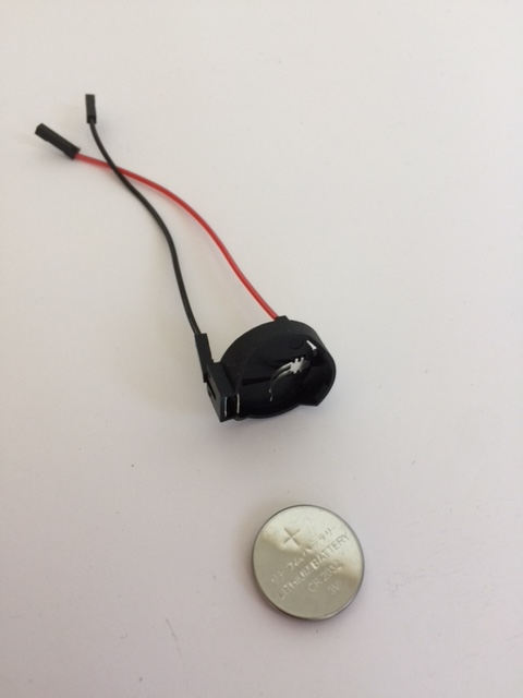 picture of coin cell battery and battery holder with jumper leads attached
