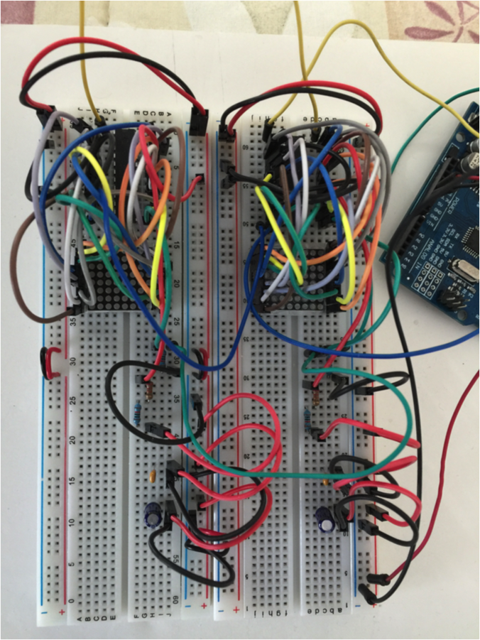 2 breadboards, each with an LED matrix wired to a controller chip