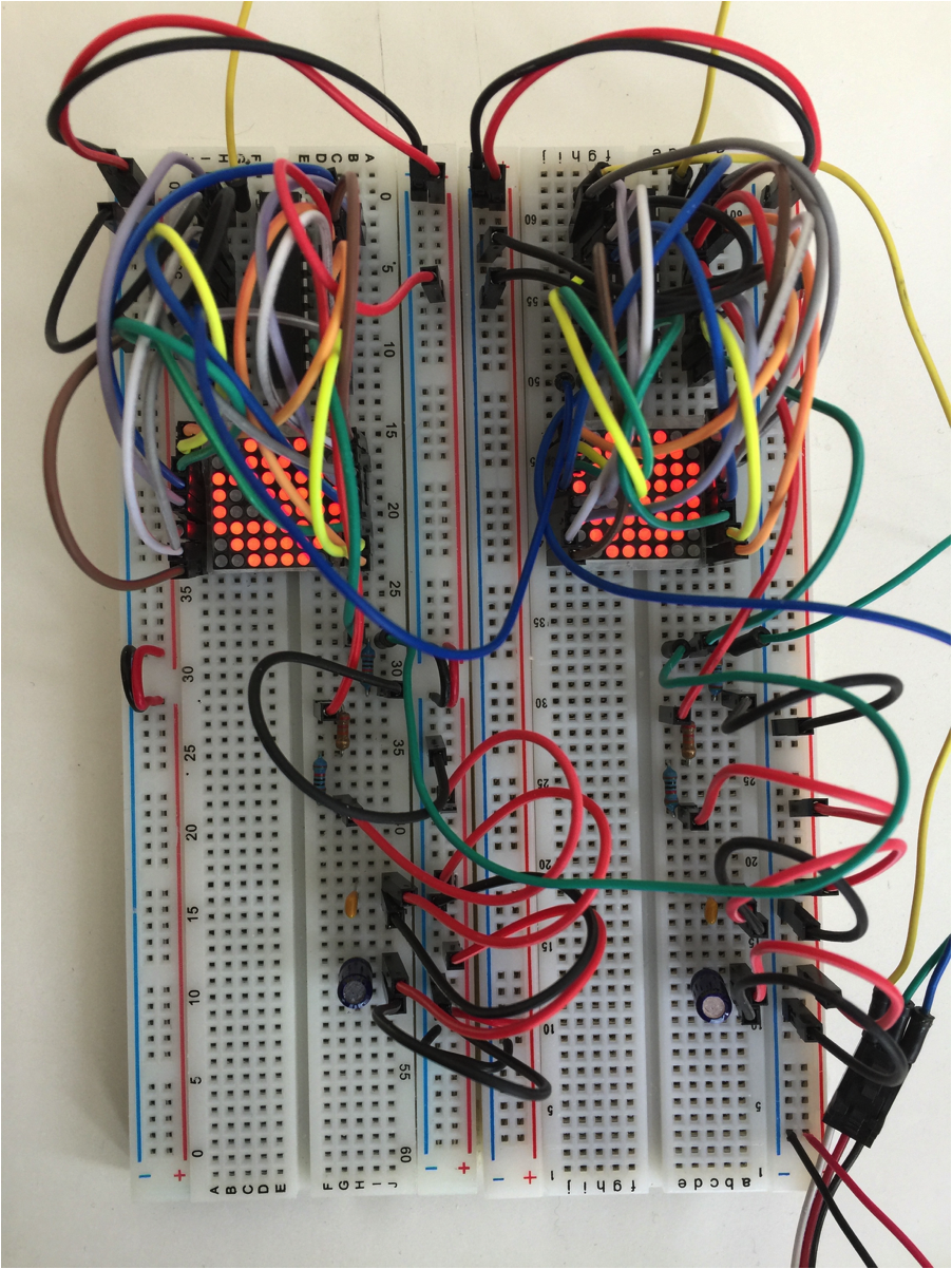 2 breadboards, 2 LED matrices and controllers, displaying eyes for pumpkin Blinky Bot kit